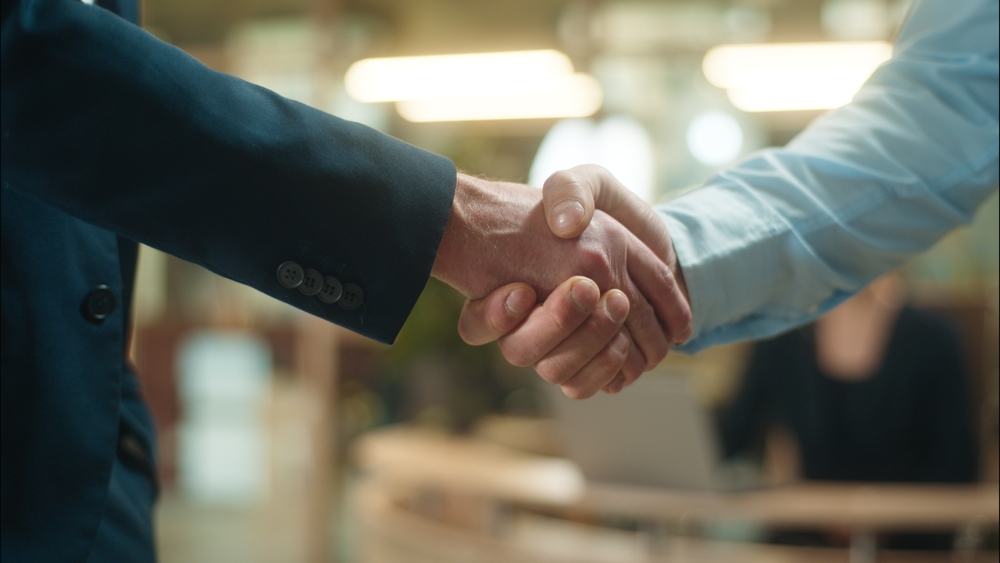 Handshake between burly men